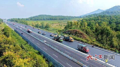 10月10日，樟吉高速公路改扩建工程A2标峡江县戈坪乡施工现场，工人在进行沥青摊铺作业。大江网视觉江西宋靖辉、范磊摄